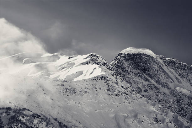 istock Black and white snowy mountains, view from ski slope 999678838