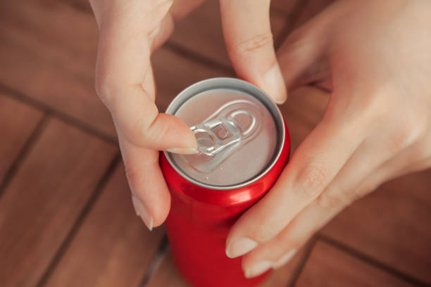 Female opening a can of tin