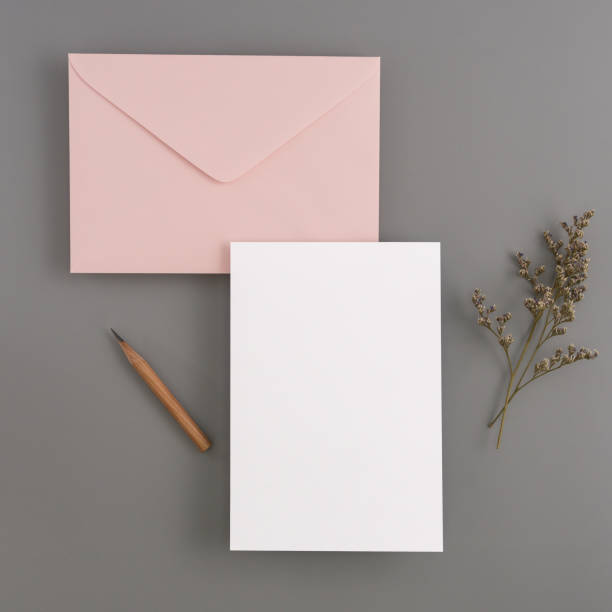 istock A wedding mock up concept. Wedding Invitation, envelopes, cards Papers on color background with ribbon and decoration. Top view, flat lay, copy space 999701320