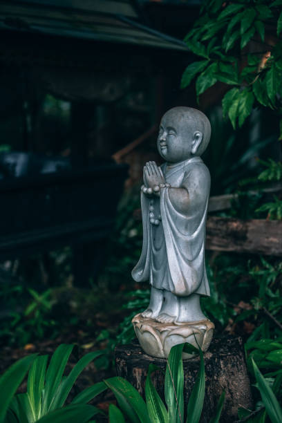 istock Young Buddhist Child Statue in Garden 999706074