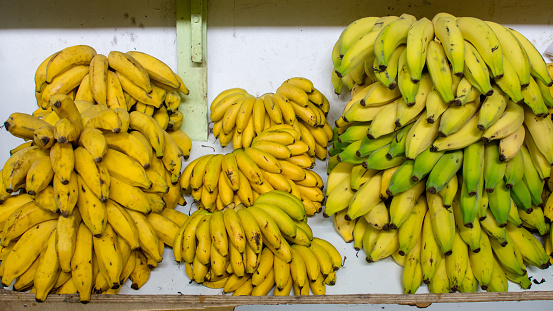 Three different varities of banana selling at a Brazilian market: banana ouro, banana prata and banana dâagua