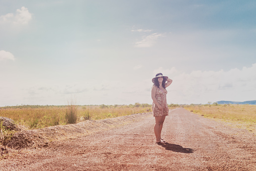 Young woman on an empty rural road