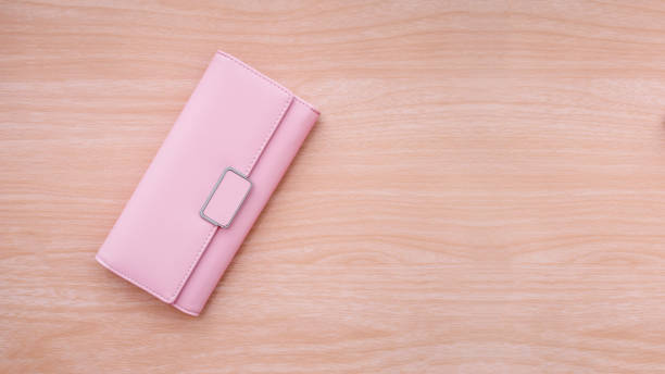 istock Pink wallet on wood table background. 999743424