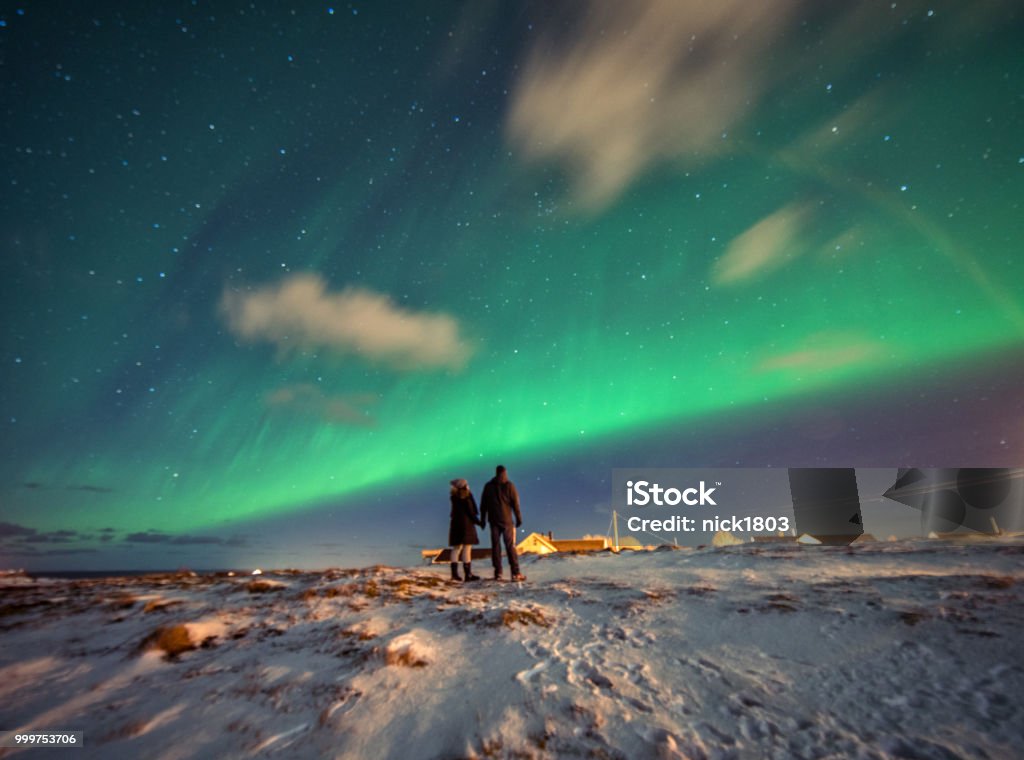 Turistas admiram a Aurora Boreal.  Reine, Noruega.  Ilhas Lofoten - Foto de stock de Aurora boreal royalty-free