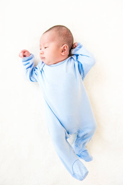istock Newborn lovely cute baby lying on white sheet 999754076