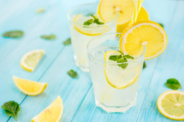 istock Refreshing drinks for summer, cold  lemonade juice with sliced fresh lemons 999756314