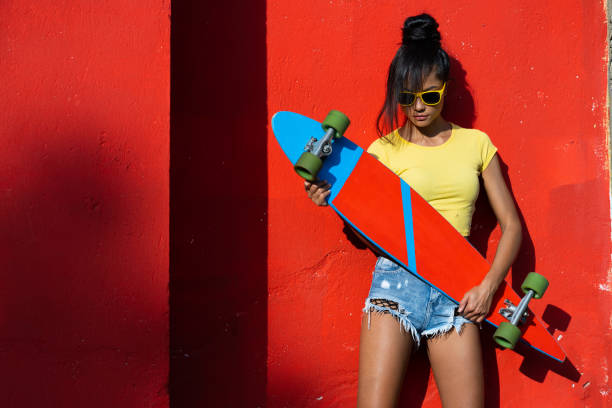 istock Beautiful skater holding longboard 999767356