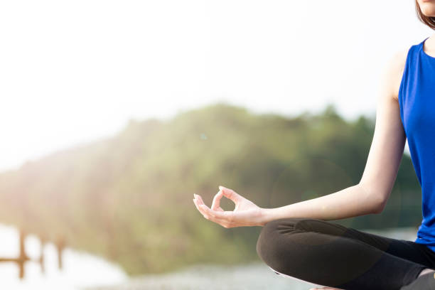 istock one women doing yoga in a nature. 999767380