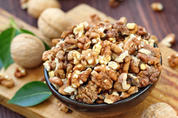 istock Peeled walnuts in wooden bowl 999774688