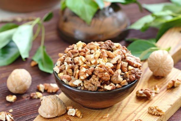 istock Peeled walnuts in wooden bowl 999774692