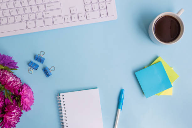 istock Blogger or freelancer workspace with notebook and pink flowers 999777880