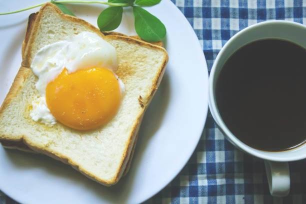 istock Fried egg on toast and black coffee in a glass. 999781554