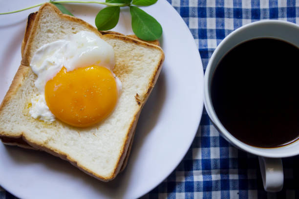istock Fried egg on toast and black coffee in a glass. 999781580