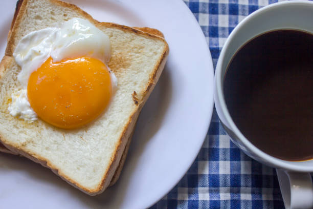 istock Fried egg on toast and black coffee in a glass. 999781632