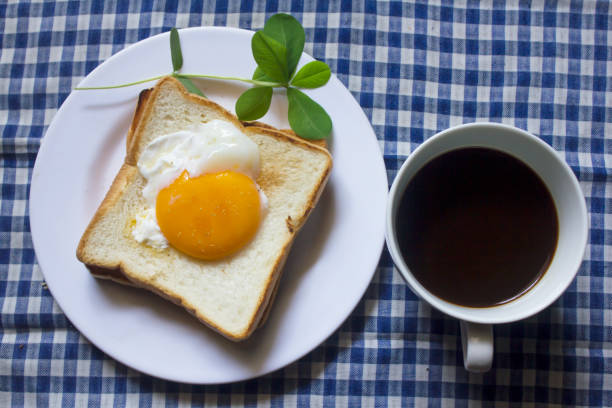 istock Fried egg on toast and black coffee in a glass. 999781634