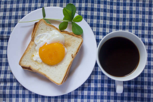 istock Fried egg on toast and black coffee in a glass. 999781650