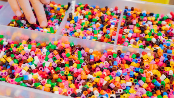 istock Plastic container with colorful kids beads. 999785226