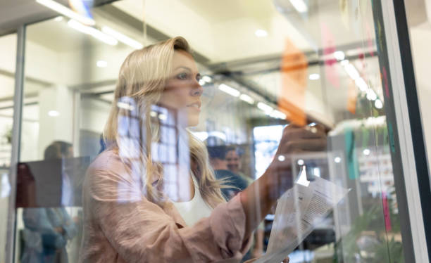 istock Woman drawing a business plan at a creative office 999790984
