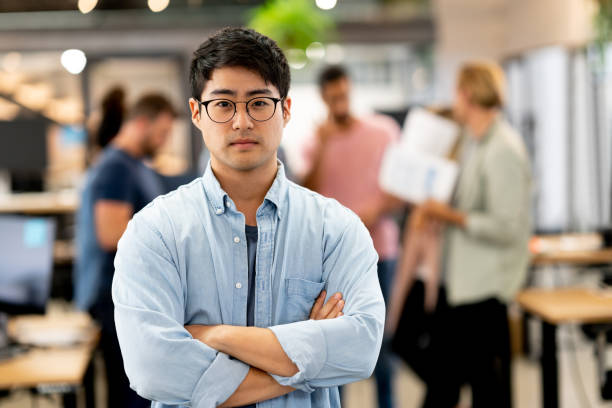 istock Portrait of a successful Asian man working at a creative office 999790988