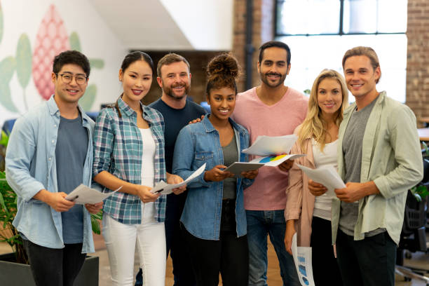 istock Happy multi-ethnic group of people working at a creative office 999791154