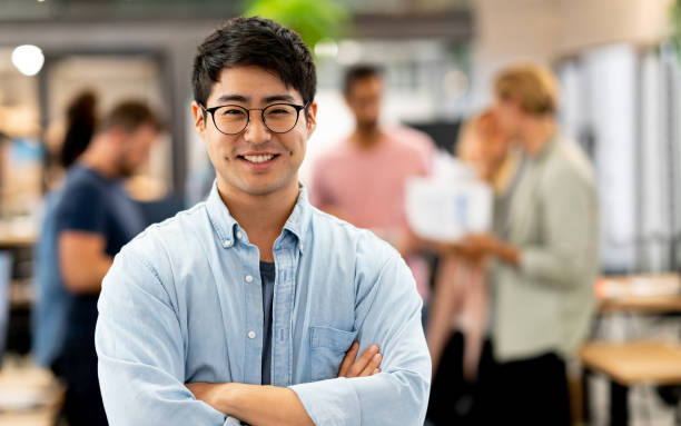 istock Asian man at a creative office with a group at the background 999791172