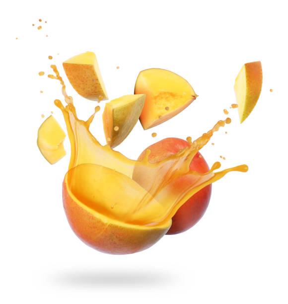 istock Mango broken into pieces with splashes of juice on white background 999796930