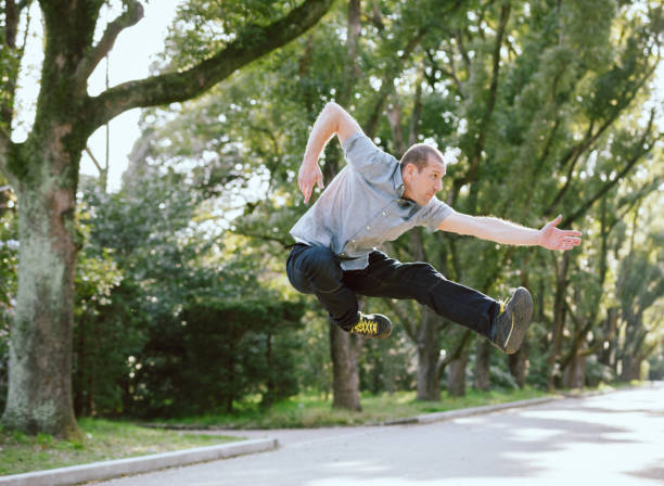 istock Caucasian men who pose jumping at the park 999797468