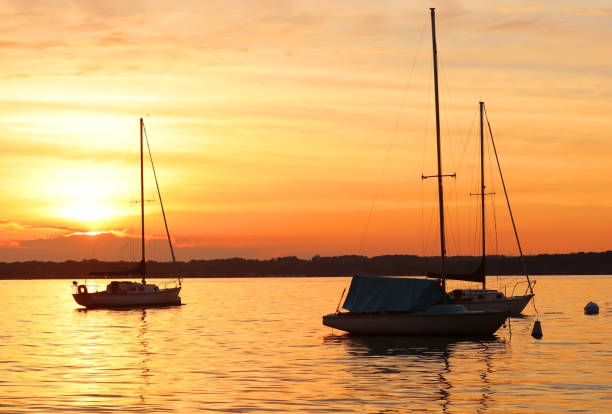 istock Yachts drifting on the lake during beautiful summer sunset. 999799846
