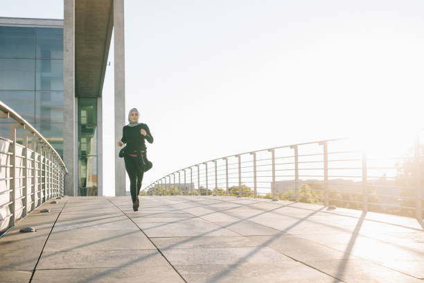 istock Woman jogging on a sunny evening. 999805576