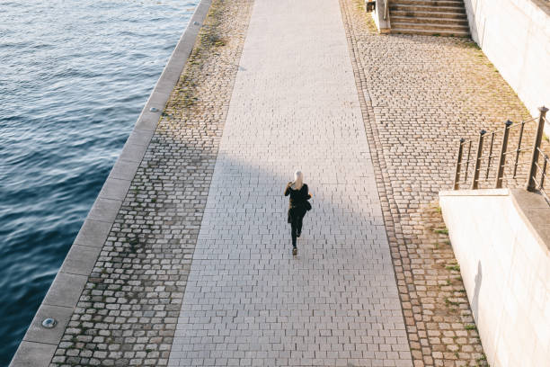 istock Woman running on a sunny evening by the river. 999805586
