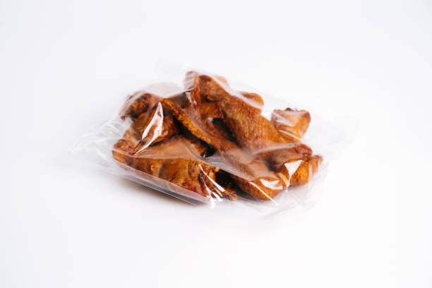 istock Smoked chicken wings in transparent plastic package 999808746