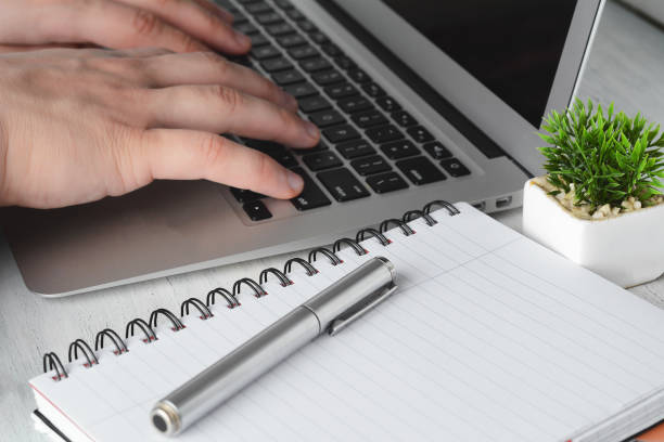 istock Close up view of senior hands with laptop 999812128