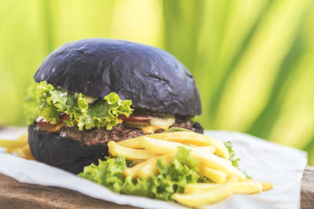 istock Burger made with black charcoal bun served 999814752