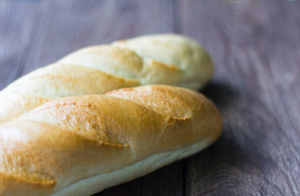 istock fresh baguettes close-up on wooden background 999815548