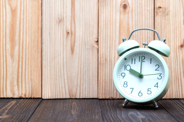 istock Retro vintage alarm clock on wood table, time concept. 999820976