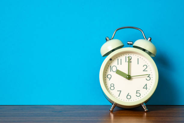 istock Retro vintage alarm clock on wood table, time concept. 999821044