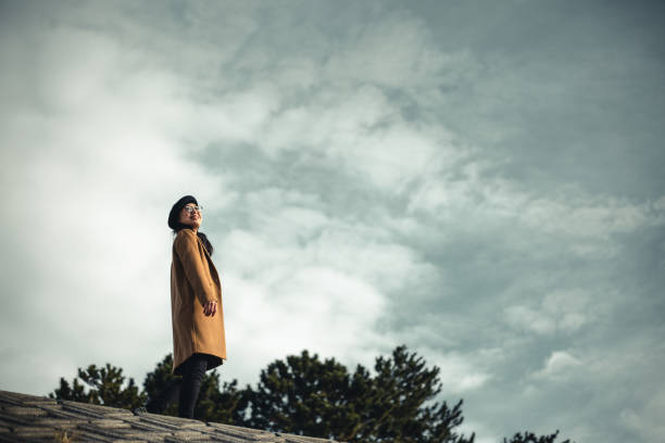 istock walking woman and blue sky 999824338