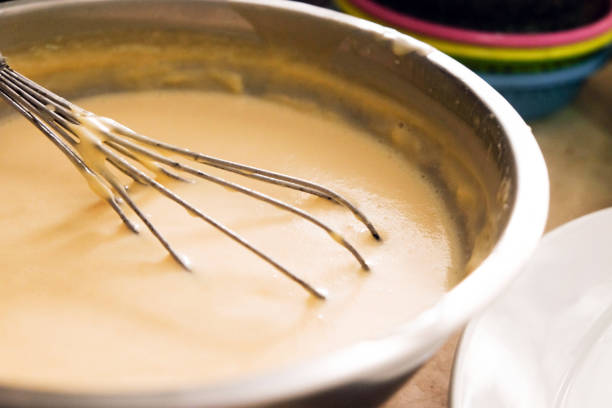 istock Mixing batter or dough for pancake or making desserts.Close up ,soft focus 999824910
