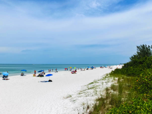 istock Tourists enjoying the Vanderbilt beach in Naples, Florida 999827714