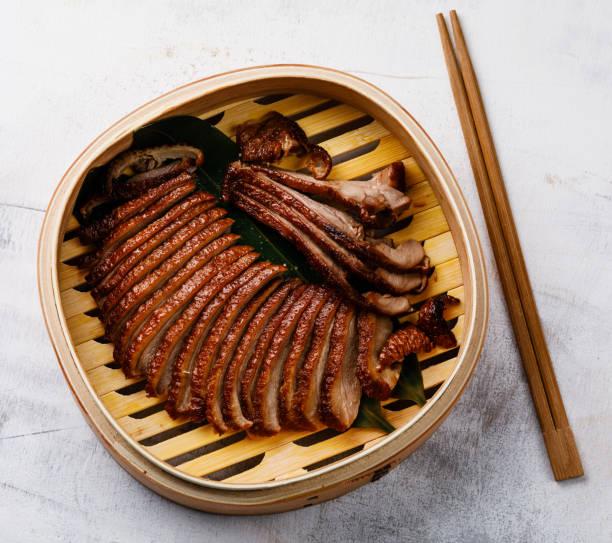 istock Sliced Peking Duck in bamboo steamer 999828398