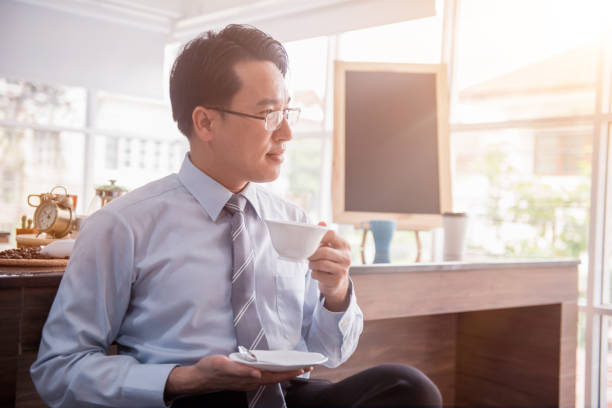istock Businessman drinking hot coffee in the morning before work. 999828514