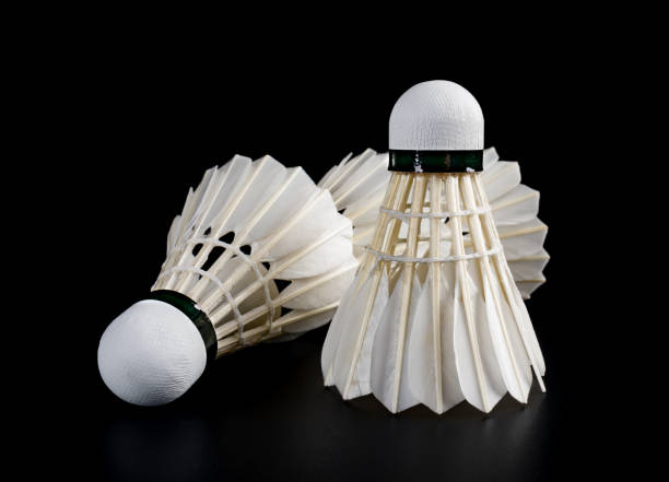 istock four brand new shuttlecocks on a black background 999831412