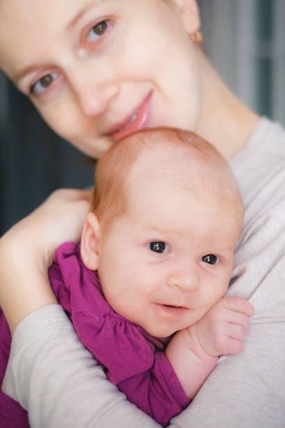istock Mum and baby smiling and hugging 999845580