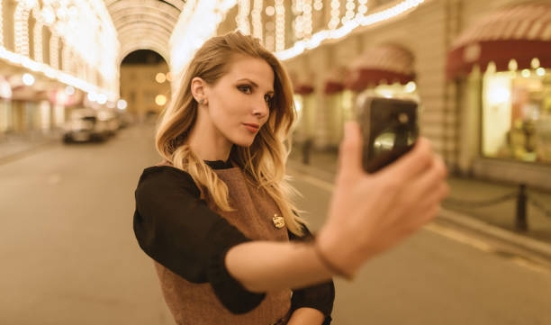 istock Woman taking selfie at night. 999846250