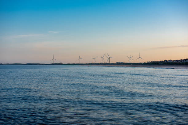 Looking over the North Sea towards an onshore wind farm at Bridlington, East Yorkshire, England.