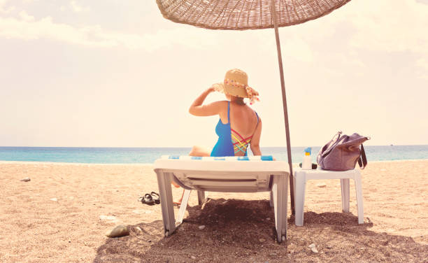 istock Young woman relaxing on the beach 999848514