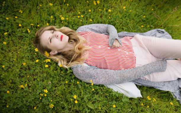 istock Young woman lying on grass. 999848590