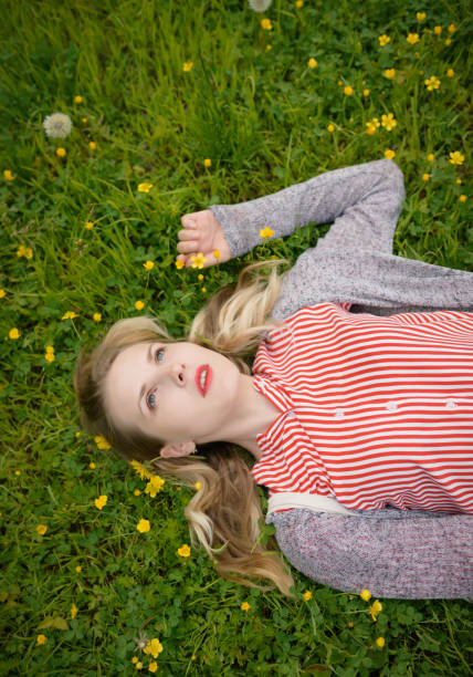 istock Young woman lying on grass. 999848730