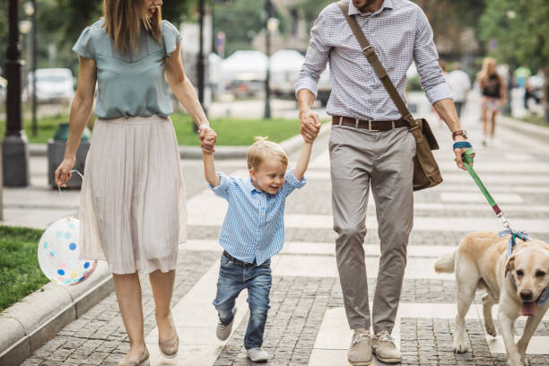 istock Family walking dog 999849196
