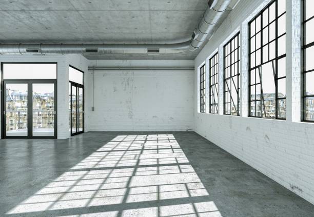 istock Empty loft room with white walls big windows and concrete floor 999851876